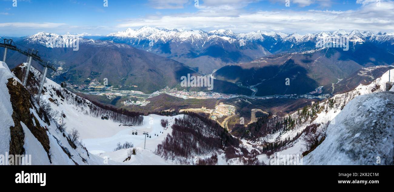 Scenic view to the city of Krasnaya Polyana and the Caucasus Mountains from the ski slopes Stock Photo