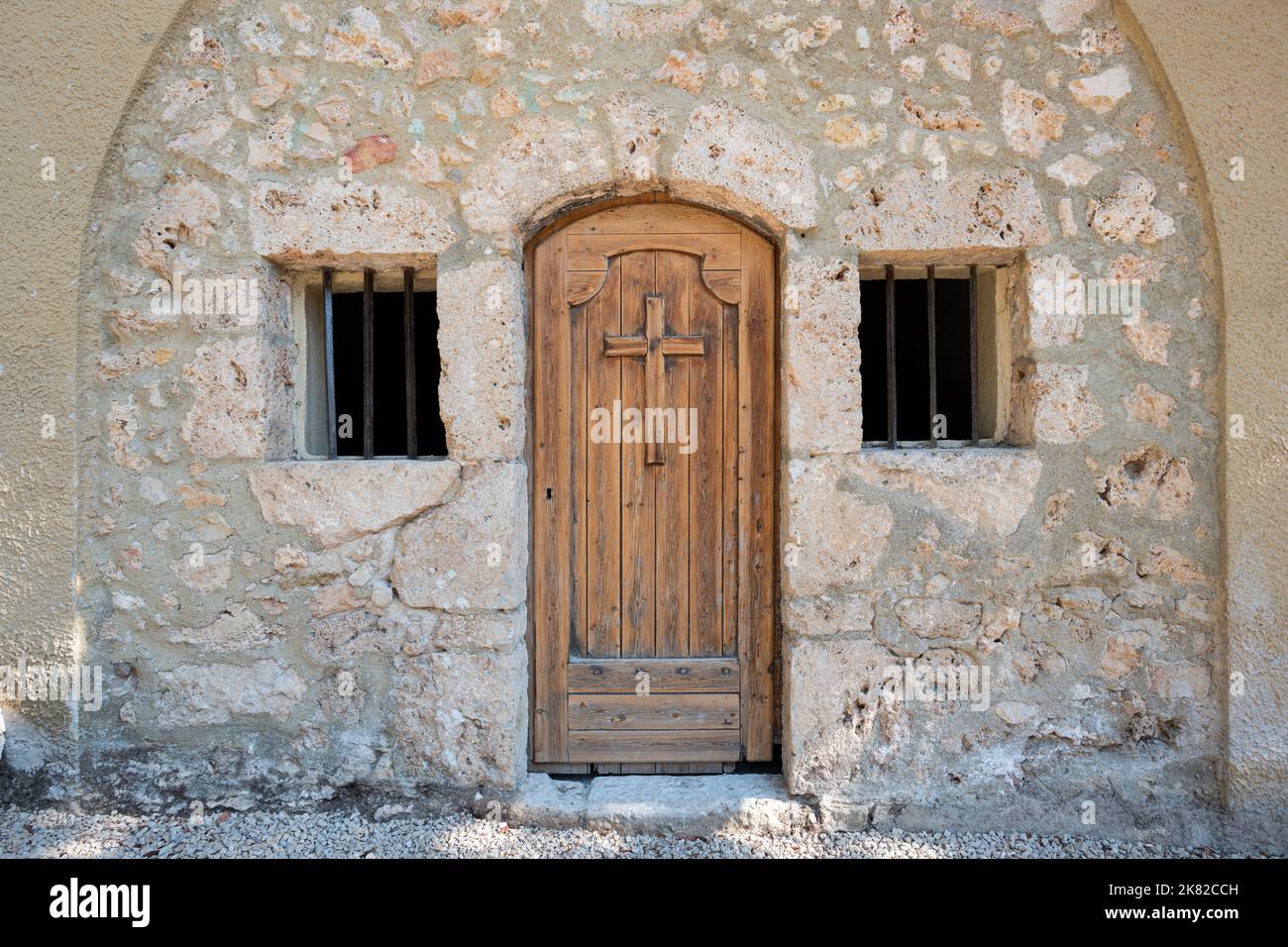 Chapel with a wooden door engraved with a cross, Tourtour, South of France Stock Photo
