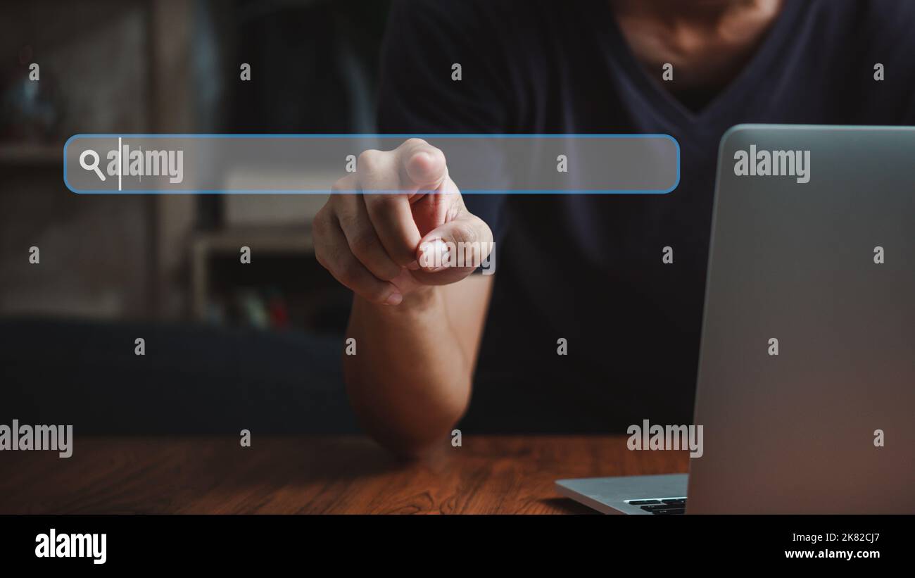 man hand searching browsing for information internet data Technology on computer keyboard notebook.SEO Search Engine Optimization. Stock Photo