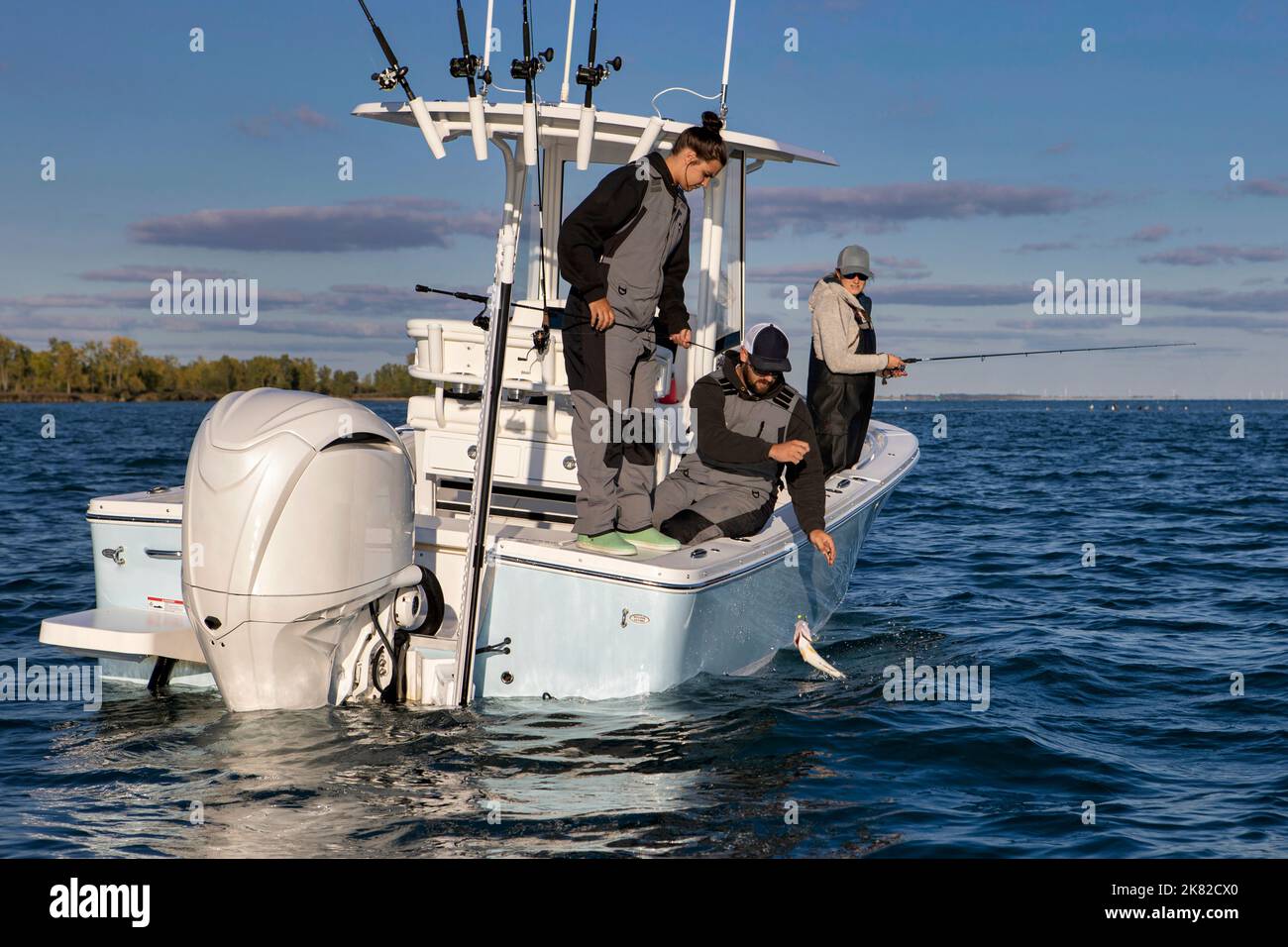 People on a boat catching a fish. Stock Photo