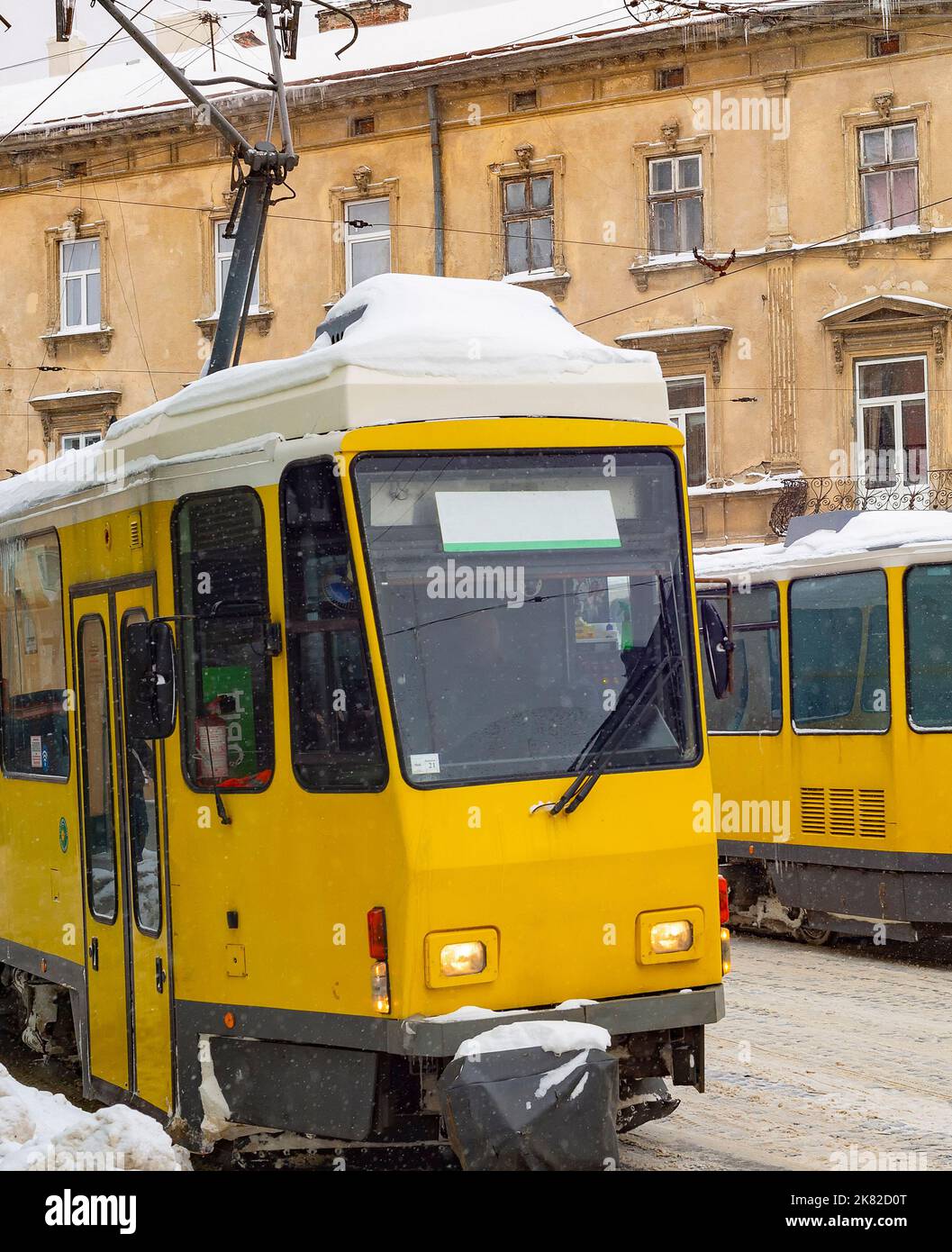 Yellow tramways, snowplow in snow collapse at the street of Lviv, Ukraine Stock Photo