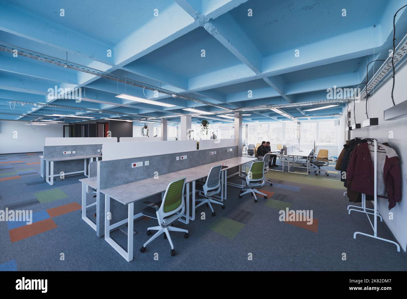 Interior of cozy light boardroom with table, modern stylish chairs and