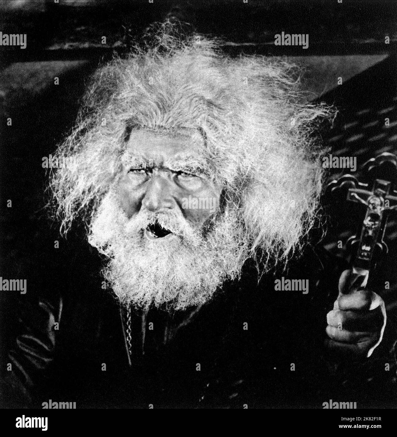 Old Man Yeilds Crucifix  Film Battleship Potemkin (Bronenosets Potemkin)   Su 1925, Director: Sergei M. Eisenstein 24 December 1925   **WARNING** This Photograph is for editorial use only and is the copyright of AMKINO CORP. and/or the Photographer assigned by the  Film or Production Company and can only be reproduced by publications in conjunction with the promotion of the above  Film. A Mandatory Credit To AMKINO CORP. is required. The Photographer should also be credited when known. No commercial use can be granted without written authority from the  Film Company. Stock Photo