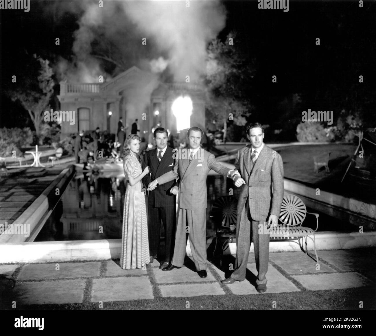 Virginia Grey, Tom Neal, William Powell & Patric Knowles Film: Another Thin Man (USA 1939) Characters: Lois MacFay / Linda Mills, Freddie Coleman, MacFay's Secretary, Nick Charles, Dudley Horn, Lois' Fiance  Director: W.S. Van Dyke 17 November 1939   **WARNING** This Photograph is for editorial use only and is the copyright of MGM and/or the Photographer assigned by the Film or Production Company and can only be reproduced by publications in conjunction with the promotion of the above Film. A Mandatory Credit To MGM is required. The Photographer should also be credited when known. No commercia Stock Photo