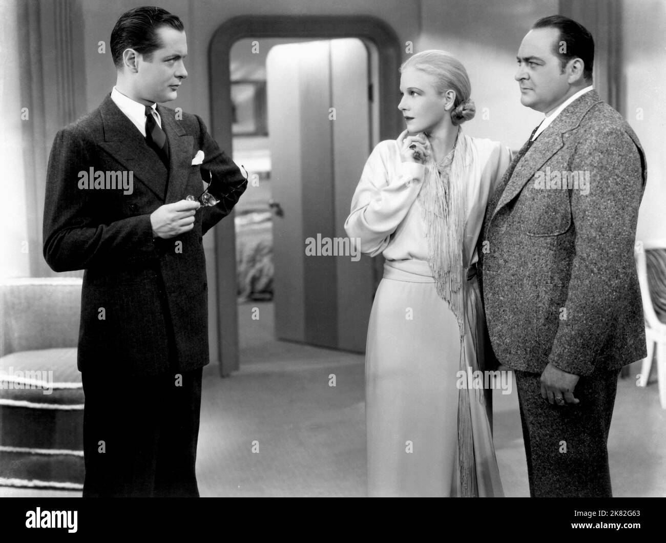 Robert Montgomery, Ann Harding & Edward Arnold Film: Biography Of A Bachelor Girl (1932) Characters: Richard 'Dickie' Kurt, Marion Forsythe, Mr. 'Feydie' Feydak  Director: Edward H.Griffith 04 January 1935   **WARNING** This Photograph is for editorial use only and is the copyright of MGM and/or the Photographer assigned by the Film or Production Company and can only be reproduced by publications in conjunction with the promotion of the above Film. A Mandatory Credit To MGM is required. The Photographer should also be credited when known. No commercial use can be granted without written author Stock Photo