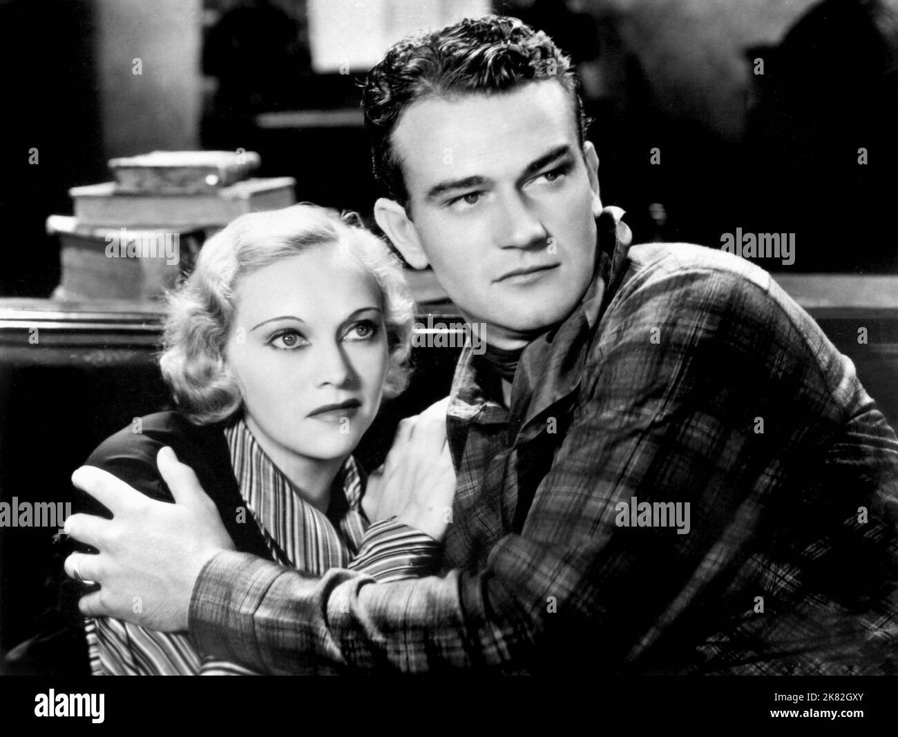 Sheila Terry & John Wayne Film: Haunted Gold (USA 1932) Characters: Janet Carter, John Mason  Director: Mack V. Wright 17 December 1932   **WARNING** This Photograph is for editorial use only and is the copyright of LEON SCHLESINGER STUDIOS and/or the Photographer assigned by the Film or Production Company and can only be reproduced by publications in conjunction with the promotion of the above Film. A Mandatory Credit To LEON SCHLESINGER STUDIOS is required. The Photographer should also be credited when known. No commercial use can be granted without written authority from the Film Company. Stock Photo