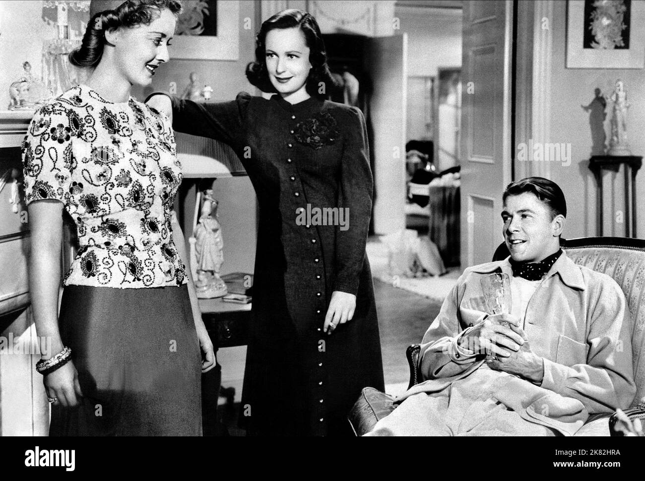 Bette Davis, Geraldine Fitzgerald & Ronald Reagan Film: Dark Victory (1929) Characters: Judith Traherne,Ann King & Alec  Director: Edmund Goulding 20 April 1939   **WARNING** This Photograph is for editorial use only and is the copyright of WARNER BROS and/or the Photographer assigned by the Film or Production Company and can only be reproduced by publications in conjunction with the promotion of the above Film. A Mandatory Credit To WARNER BROS is required. The Photographer should also be credited when known. No commercial use can be granted without written authority from the Film Company. Stock Photo