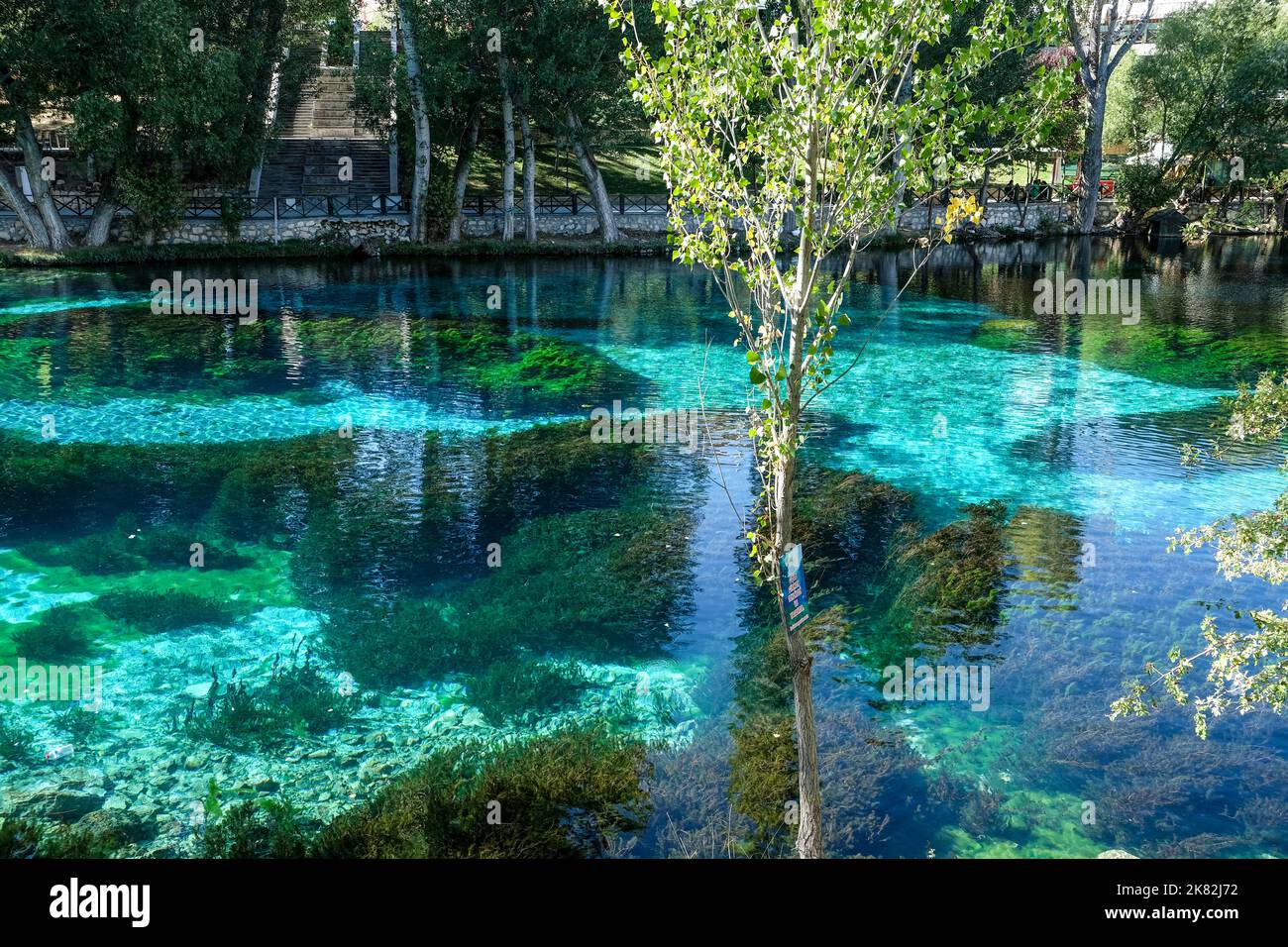 Lake Gökpınar, dubbed a “natural aquarium,” enchants visitors as fall colors merge with its crystal-clear turquoise-hued waters. Stock Photo