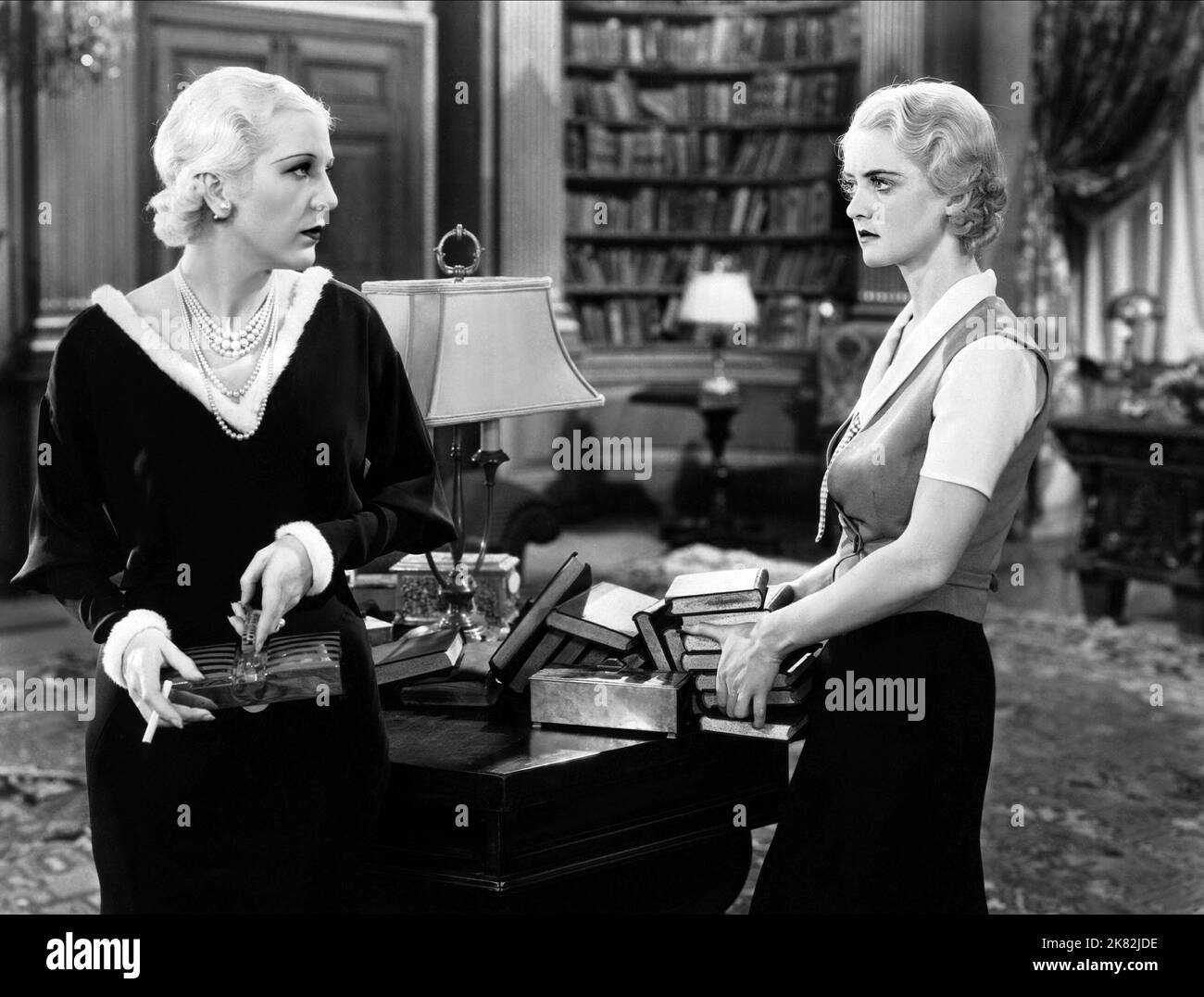 Natalie Moorhead & Bette Davis  Film The Menace (1936) Characters: Caroline Quayle, Peggy Lowell  Director: Roy William Neill 29 January 1932   **WARNING** This Photograph is for editorial use only and is the copyright of COLUMBIA and/or the Photographer assigned by the  Film or Production Company and can only be reproduced by publications in conjunction with the promotion of the above  Film. A Mandatory Credit To COLUMBIA is required. The Photographer should also be credited when known. No commercial use can be granted without written authority from the  Film Company. Stock Photo