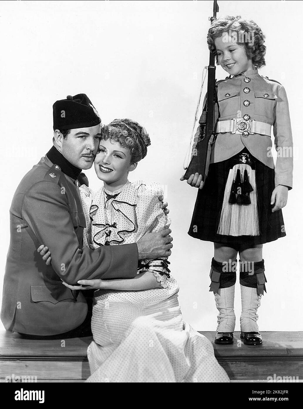Michael Whalen, June Lang & Shirley Temple Film: Wee Willie Winkie (1939) Characters: Lt. 'Coppy' Brandes, Joyce Williams, Priscilla 'Winkie' Williams  Director: John Ford 30 July 1937   **WARNING** This Photograph is for editorial use only and is the copyright of 20TH CENTURY FOX and/or the Photographer assigned by the Film or Production Company and can only be reproduced by publications in conjunction with the promotion of the above Film. A Mandatory Credit To 20TH CENTURY FOX is required. The Photographer should also be credited when known. No commercial use can be granted without written a Stock Photo