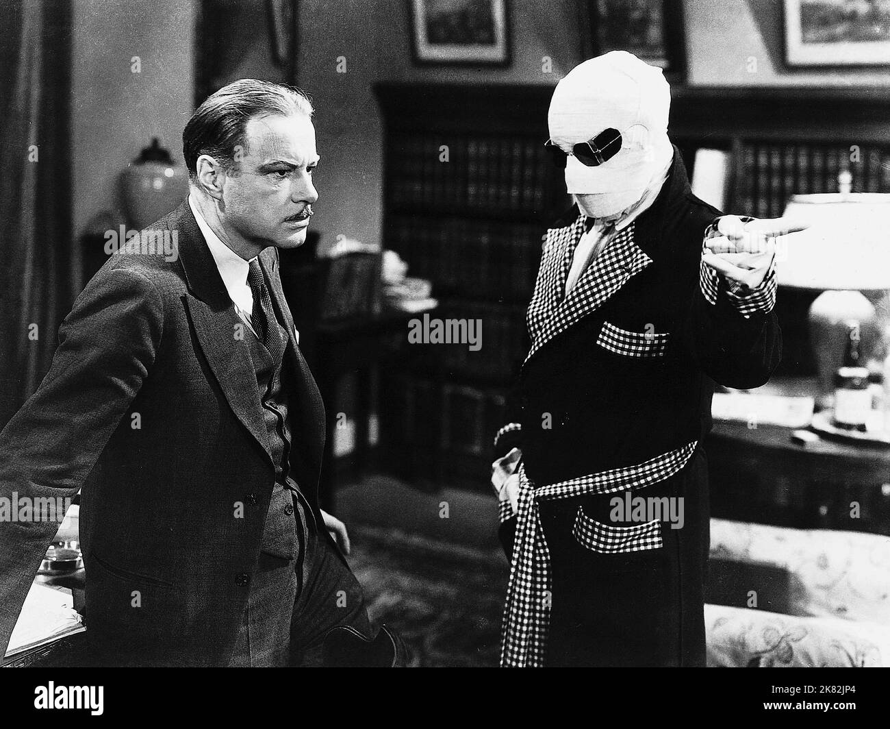 William Harrigan & Claude Rains Film: The Invisible Man (1936) Characters: Dr. Arthur Kemp & Jack Griffin / The Invisible Man  Director: James Whale 13 November 1933   **WARNING** This Photograph is for editorial use only and is the copyright of UNIVERSAL and/or the Photographer assigned by the Film or Production Company and can only be reproduced by publications in conjunction with the promotion of the above Film. A Mandatory Credit To UNIVERSAL is required. The Photographer should also be credited when known. No commercial use can be granted without written authority from the Film Company. Stock Photo