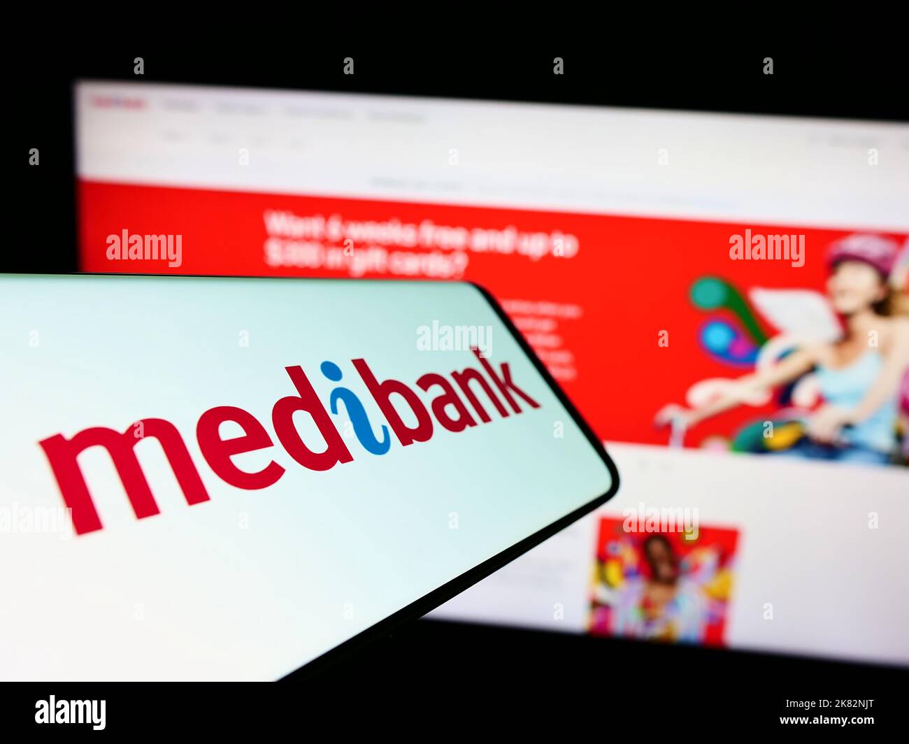 Smartphone with logo of health insurance company Medibank Private Limited on screen in front of website. Focus on center-left of phone display. Stock Photo