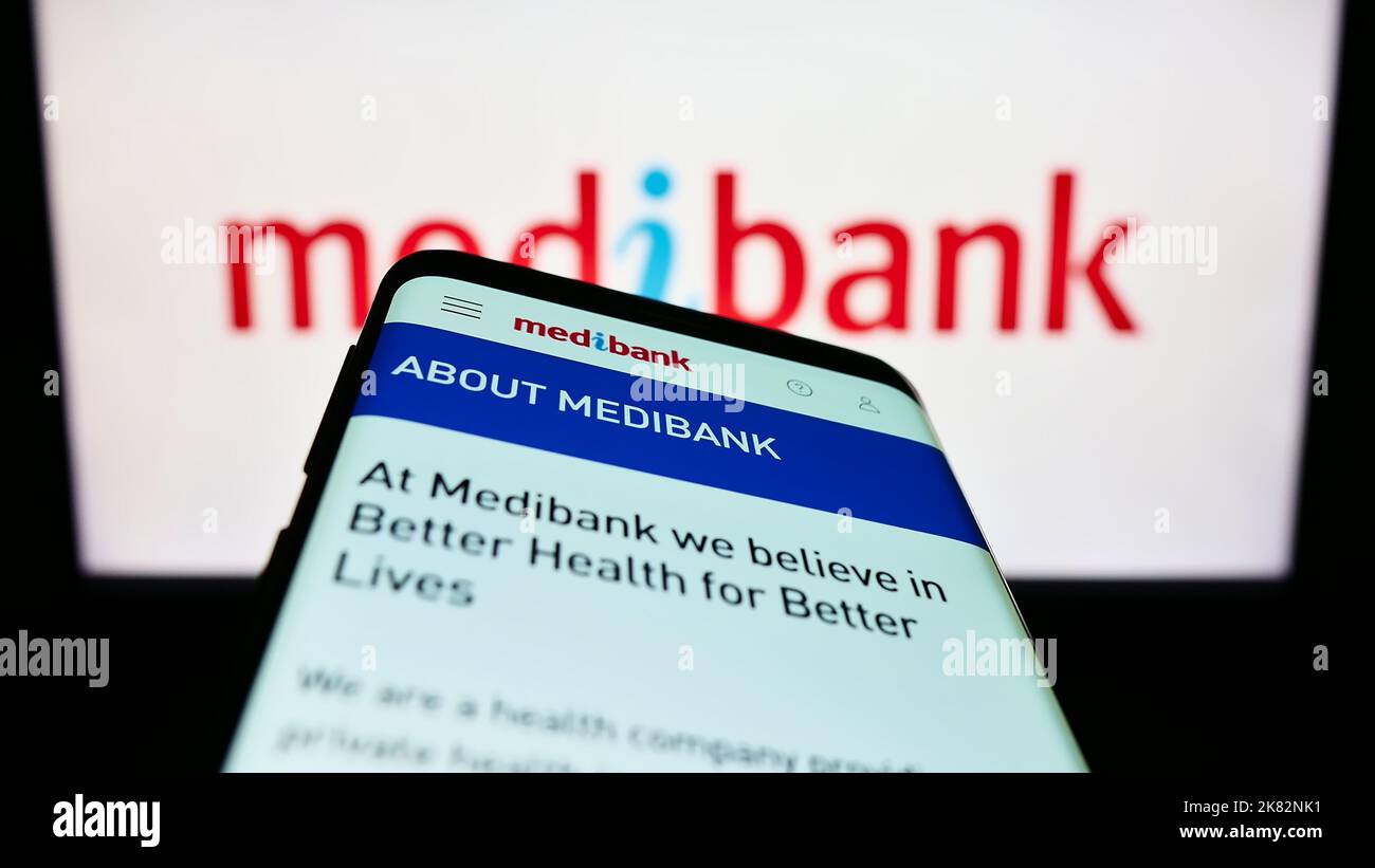 Mobile phone with website of health insurance company Medibank Private Limited on screen in front of logo. Focus on top-left of phone display. Stock Photo