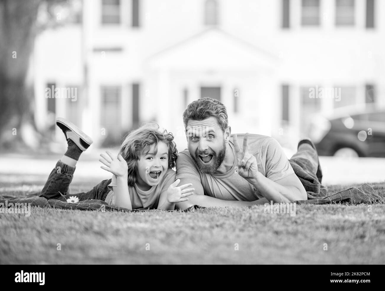 childhood and parenthood. parent relax with little child boy on grass. dad with kid Stock Photo