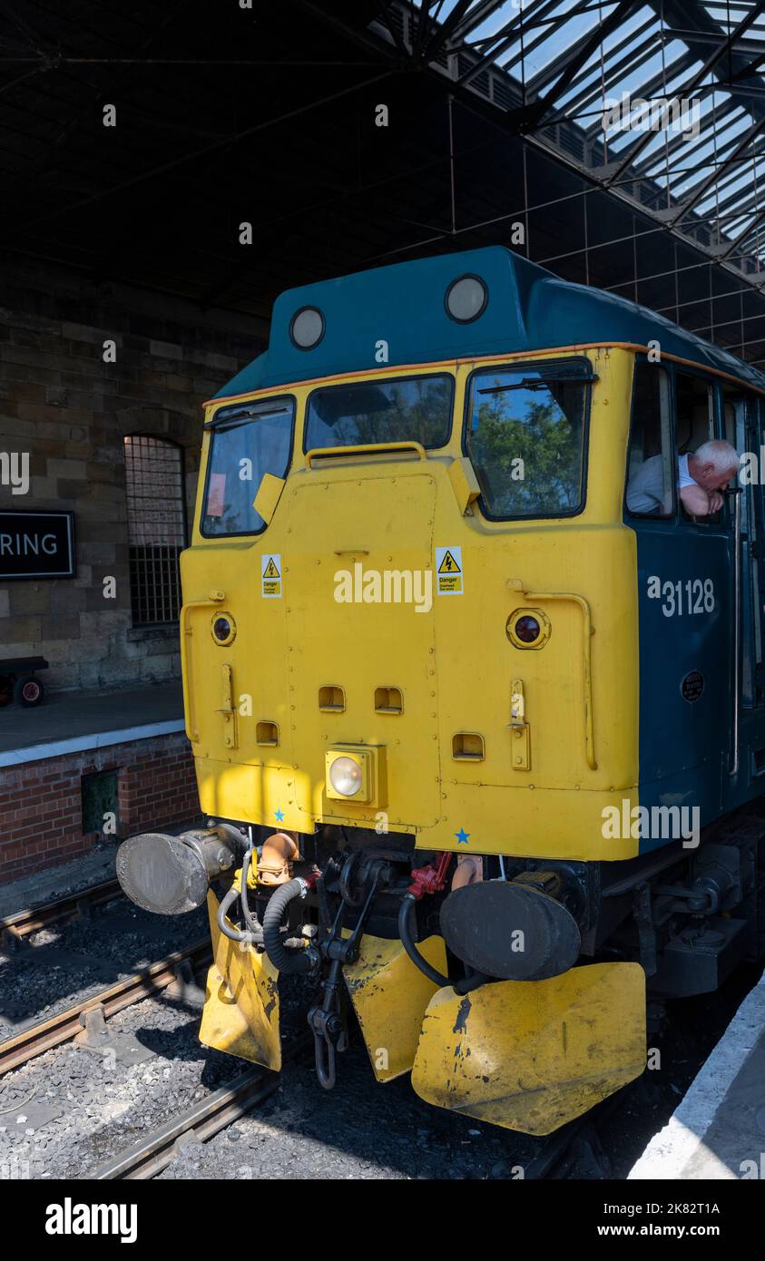 The British Rail Class 31 No. 31128 Charybdis - diesel locomotive - arrives at Pickering Railway station on the North Yorkshire Moors Railway, Stock Photo