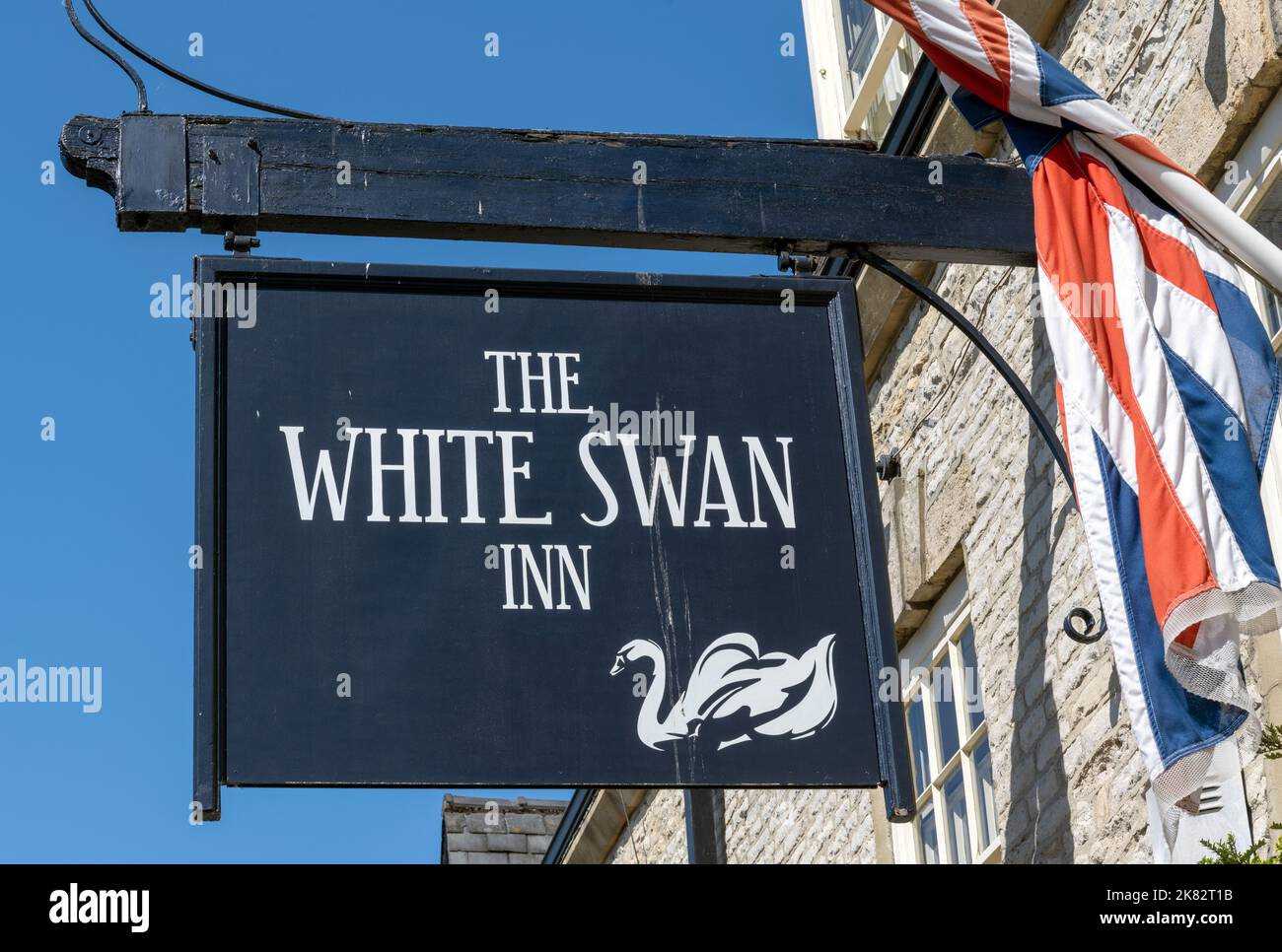 Traditional hanging pub sign at The White Swan Inn - public house - Market Place, Pickering, North Yorkshire, Yorkshire, England, UK Stock Photo