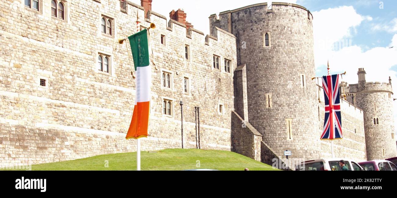 Windsor Castle with flags (Union Jack and Eire's National Flag), Windsor, Berkshire, UK.  Work on this Norman Castle was begun by William the Conquero Stock Photo