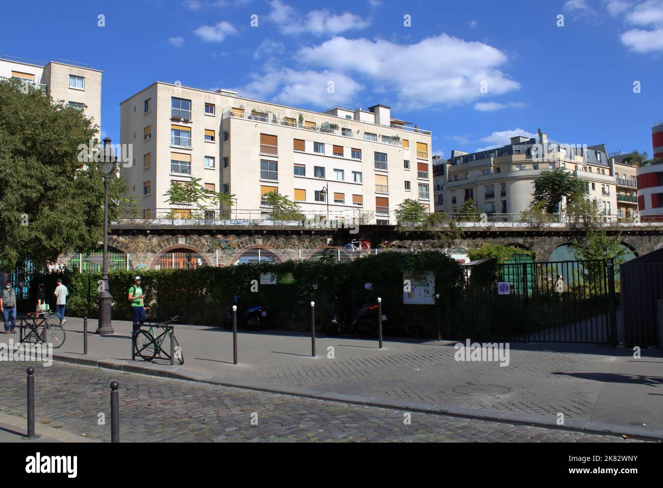 View of the trainline and residential buildings along the Bassin de la Villette located in the 19th Arrondissement in Paris France. Stock Photo