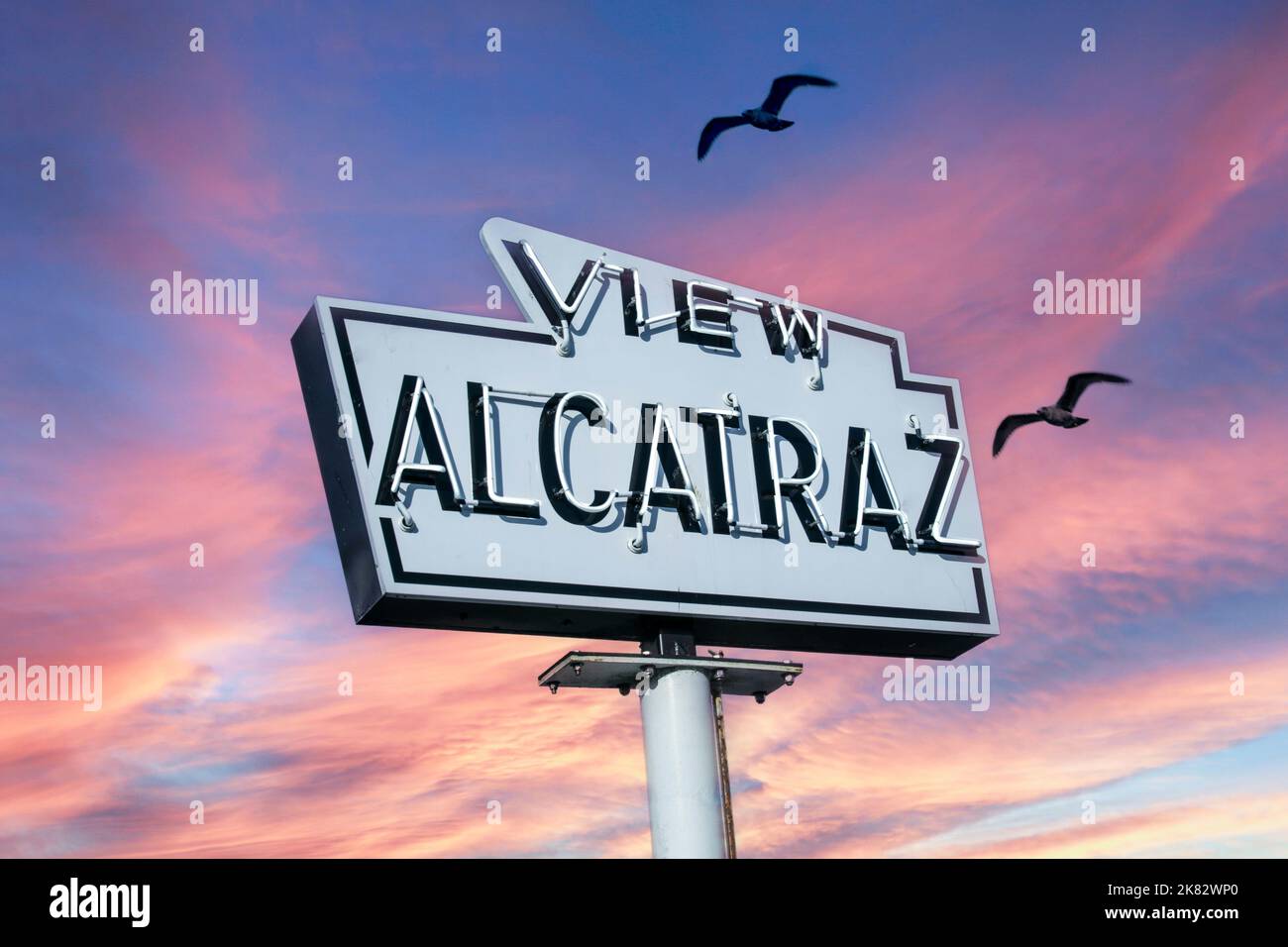 Alcatraz prison sign attraction boat trip at sunset with seagulls flying past Ferry Terminal on Pier 41 The Embarcadero San Francisco California USA Stock Photo