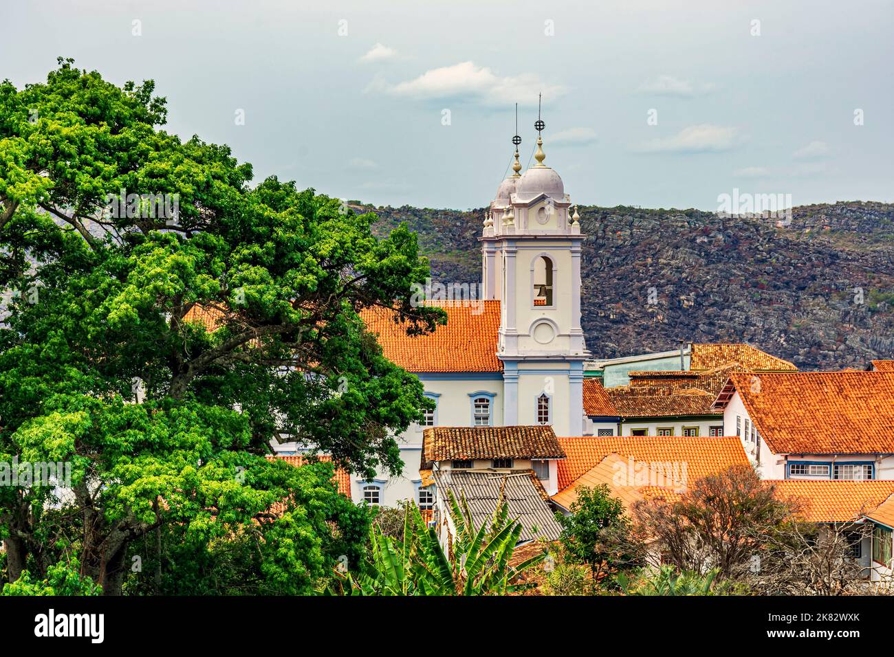 Towers of the cathedral of the historic city of Diamantina in Minas Gerais among the roofers and with the mountains in the background Stock Photo