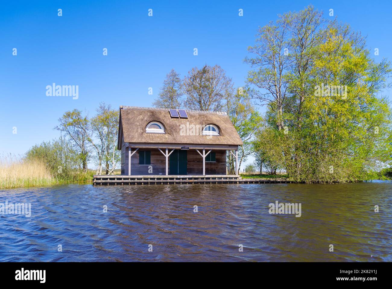 small thatched house at a lake Stock Photo