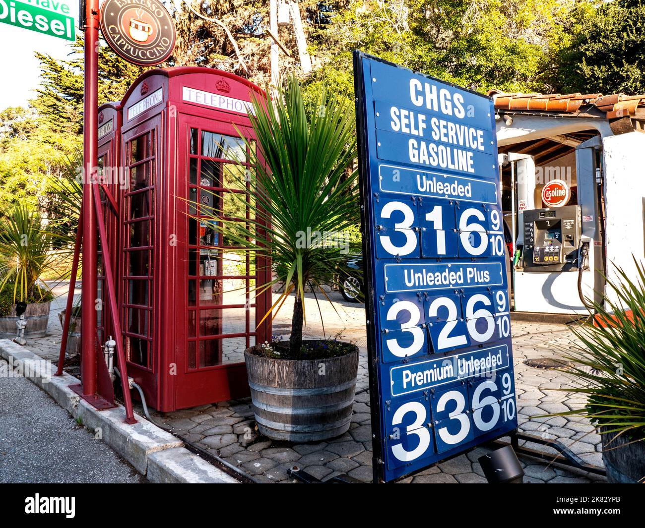 Historic USA AMERICA Gasoline Petrol station prices boards in 2014 at Carmel Monterey California, with traditional vintage retro working red English telephone boxes attraction outside, in Monterey County California USA Stock Photo