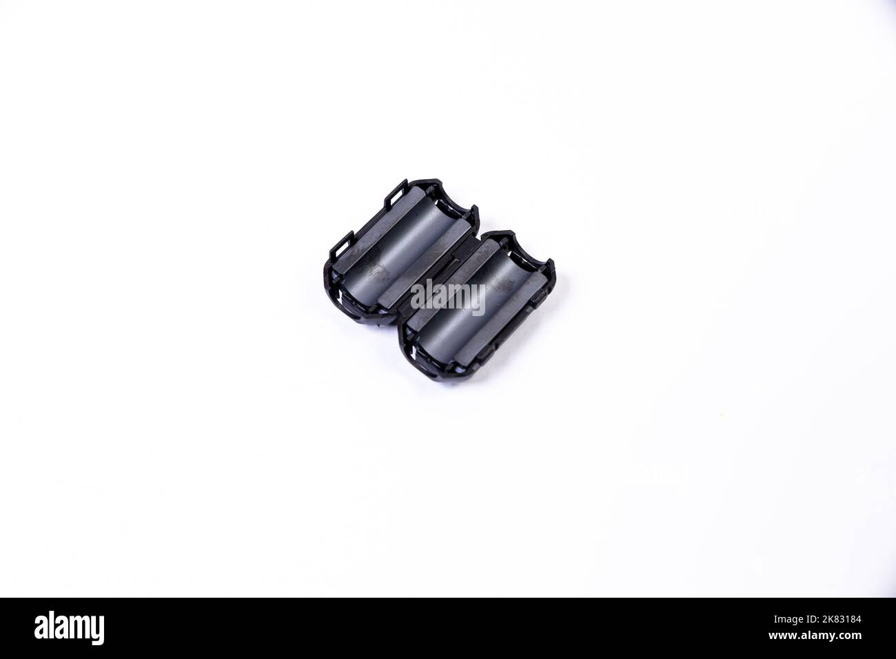 Close up of a ferrite bead inductor. An electrical element that suppresses high-frequency electronic noise in electronic circuits. on isolated white Stock Photo