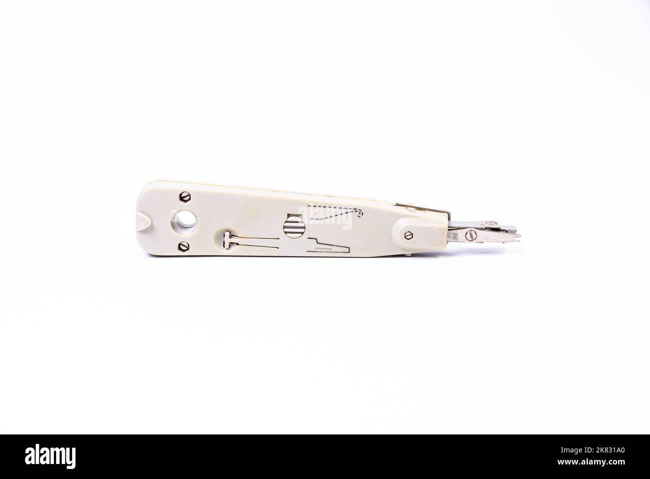 Hand crimp tool for crimping of the round terminals and small heap of blue insulated terminals on a white background Stock Photo