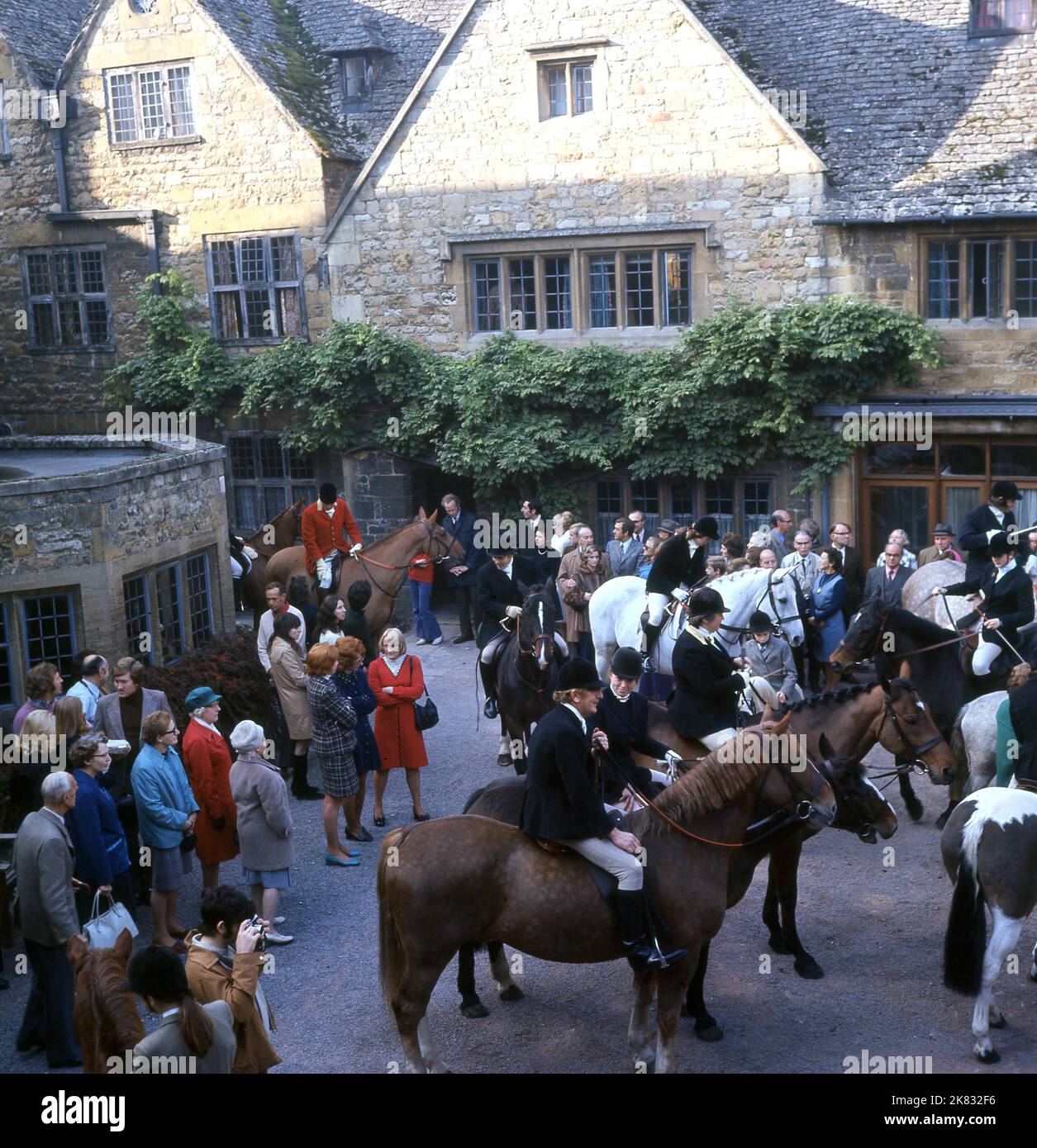 1960s, historical, dressed in their tunics anf breeches, members of the local fox hunt on their horses gathered in the village before the hunt, Cotswolds, England, UK. Stock Photo