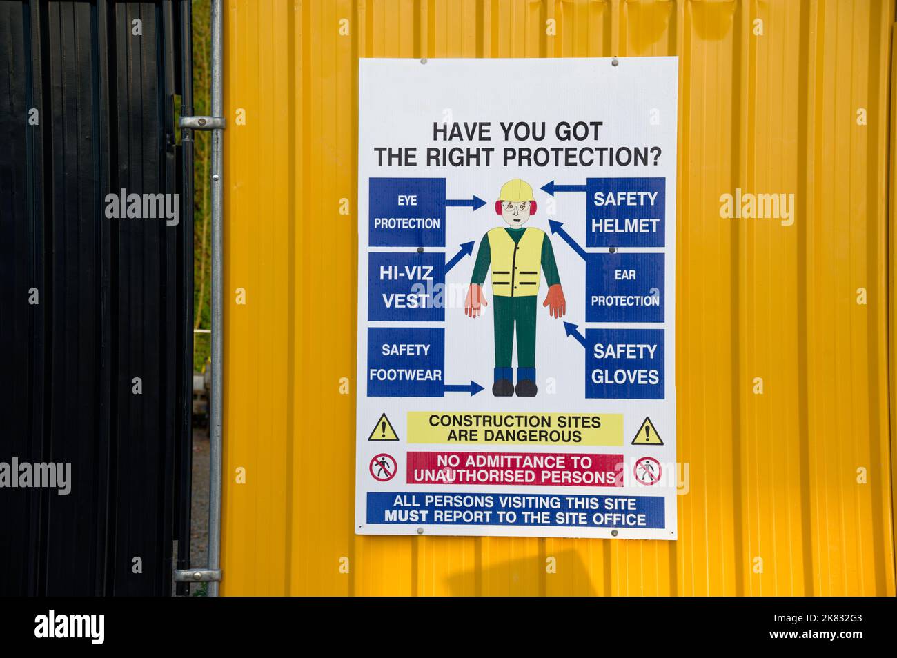 Construction site health and safety message rules sign board signage on fence boundary Stock