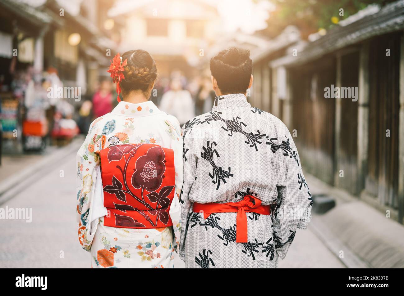 Young Man and Young women wearing traditional Japanese Kimono with colorful maple trees in autumn is famous in autumn color leaves and cherry blossom Stock Photo