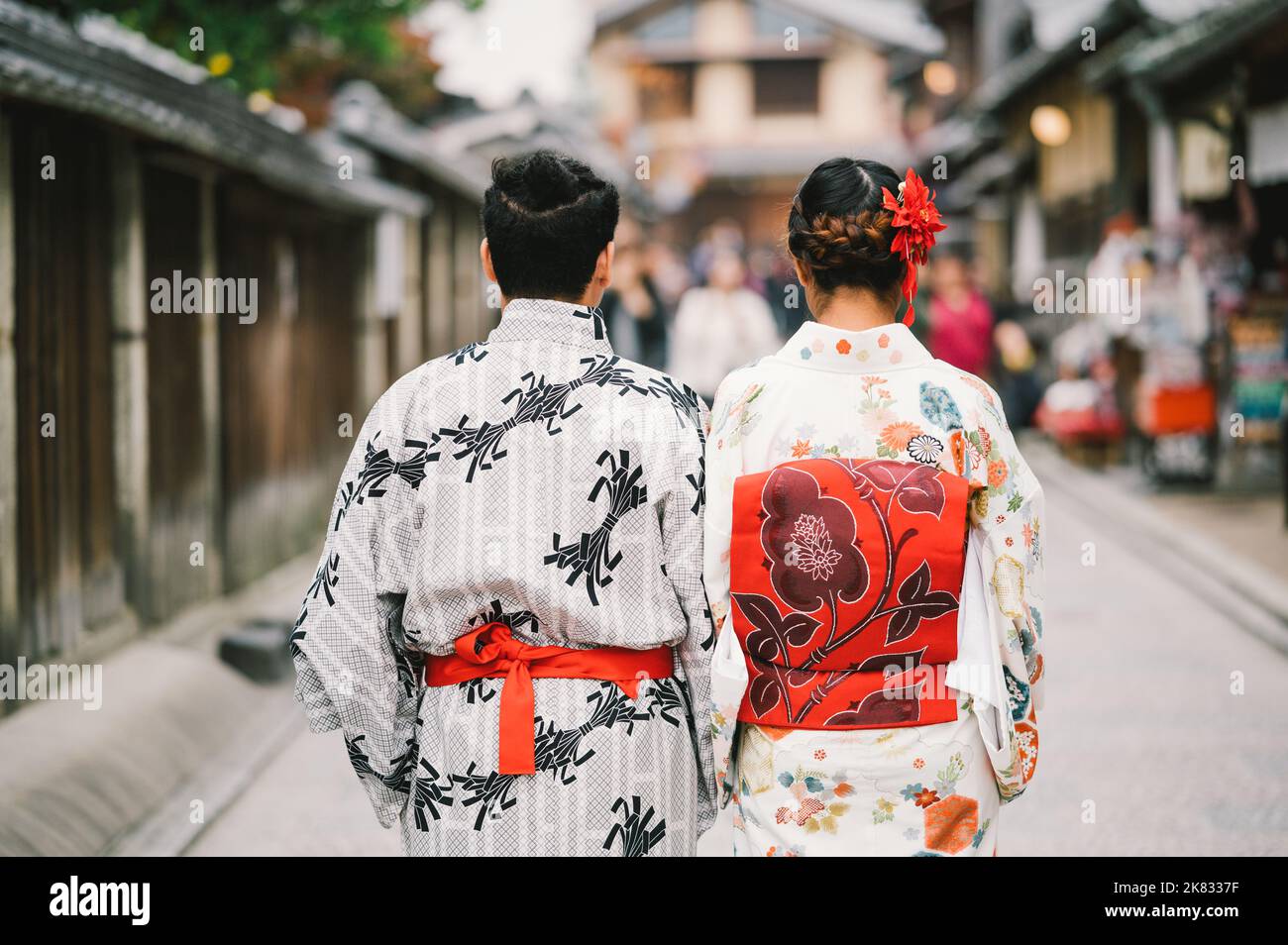 Young Man and Young women wearing traditional Japanese Kimono with colorful maple trees in autumn is famous in autumn color leaves and cherry blossom Stock Photo