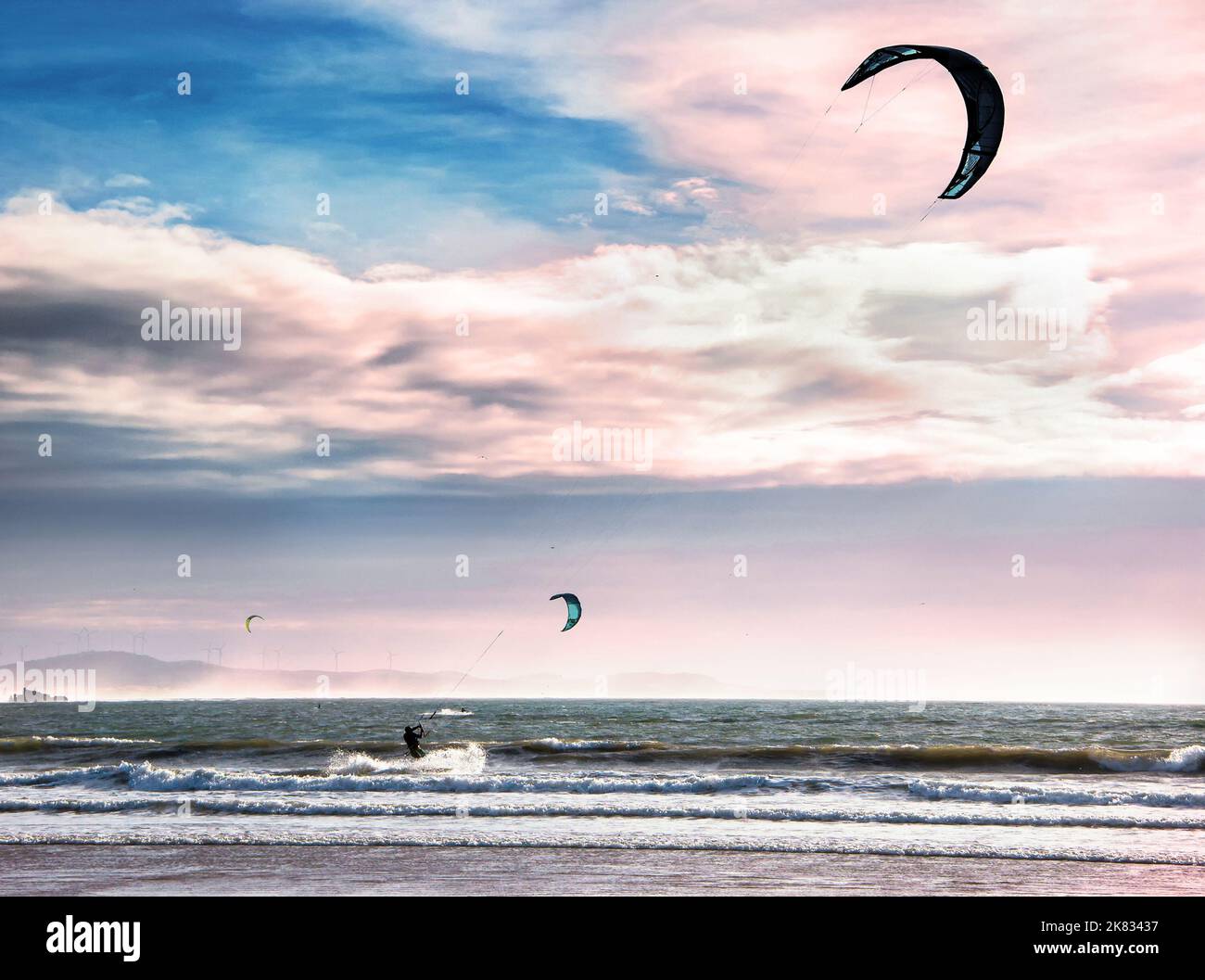 Kite surfers on the waves of the Atlantic ocean. Active leisure concept Stock Photo