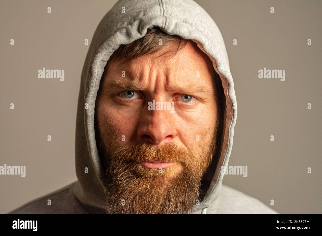man with hood on a dark background depression or hacker Stock Photo