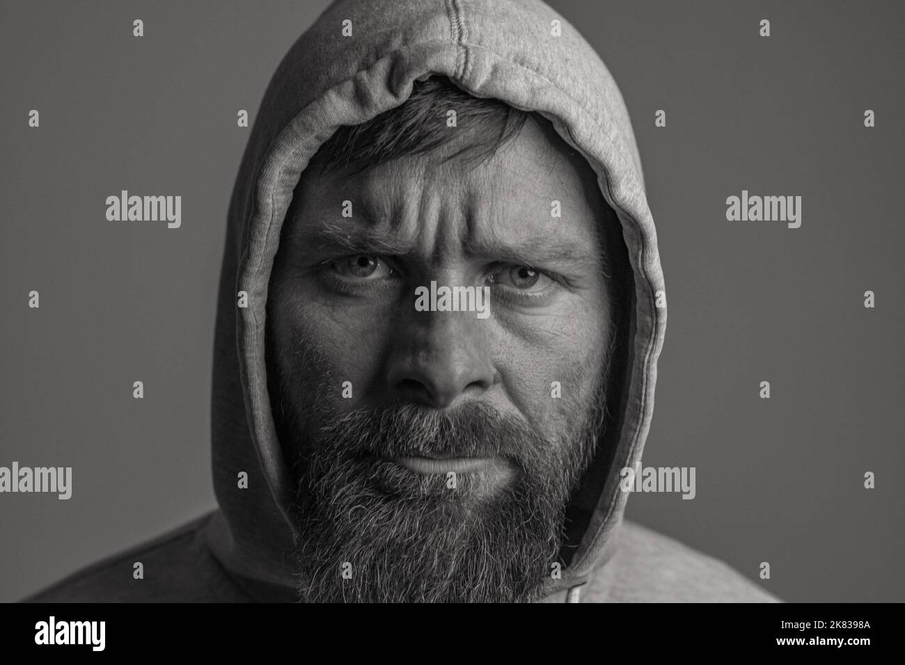 man with hood on a dark background depression or hacker Stock Photo