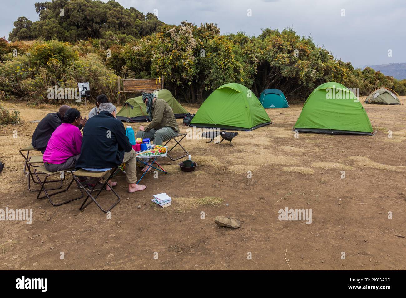 SIMIEN MOUNTAINS, ETHIOPIA - MARCH 15, 2019: Tourists in Sankaber camping in Simien mountains, Ethiopia Stock Photo