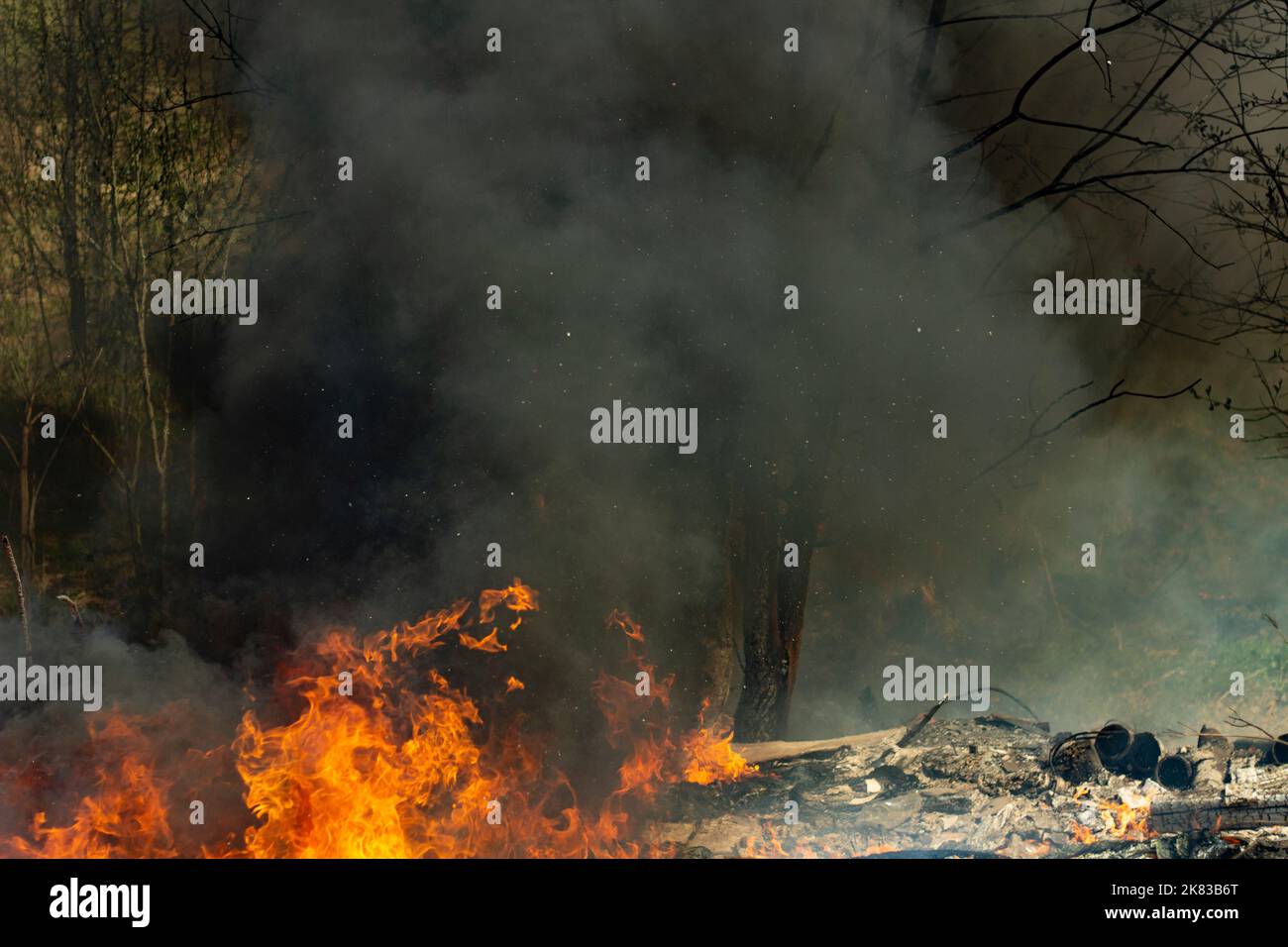 Fire in street. Smoke and fire. Landfill is burning. Environmental hazards. Air pollution Stock