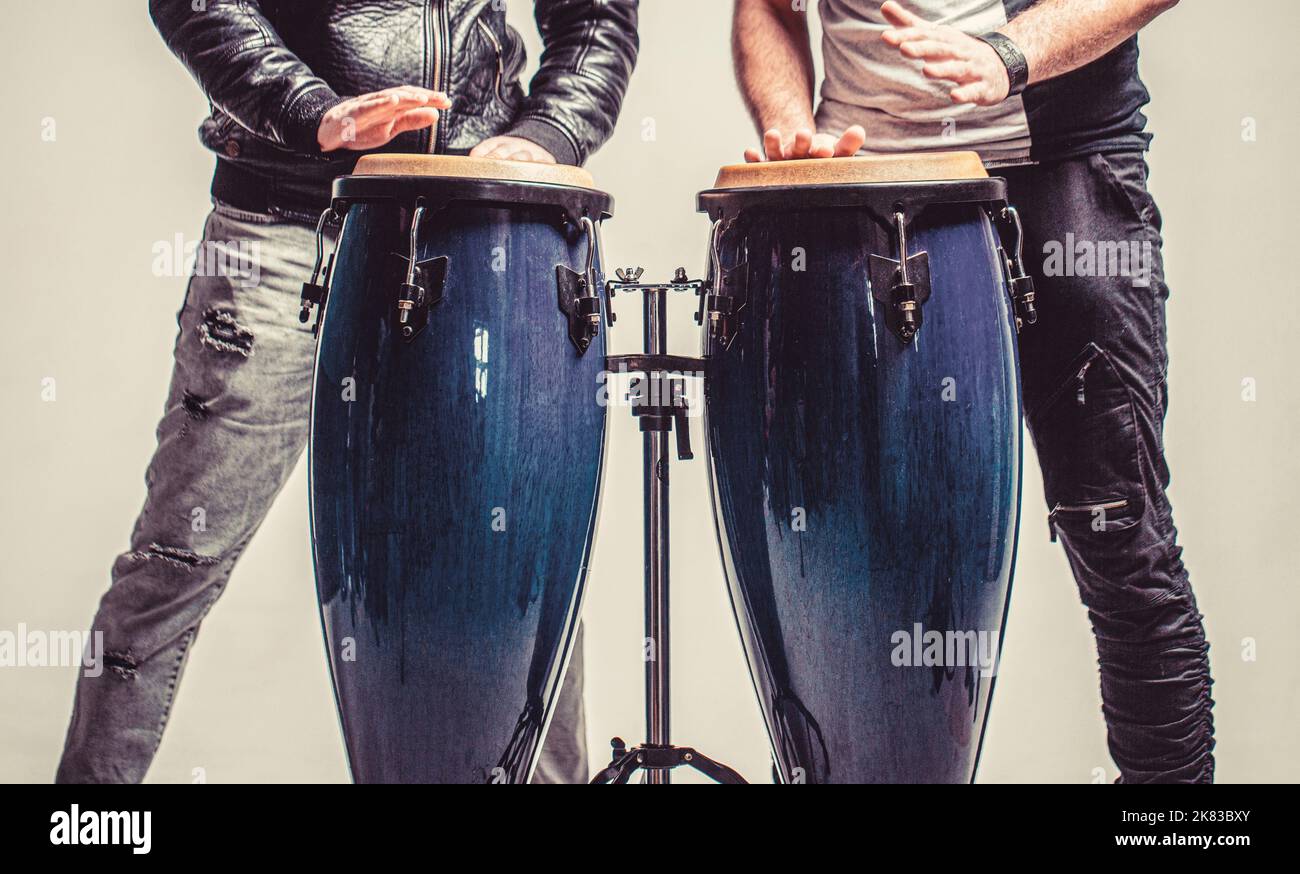 Performers playing bongo drums. Close up of musician hand playing bongos drums. AfroCuba, rum