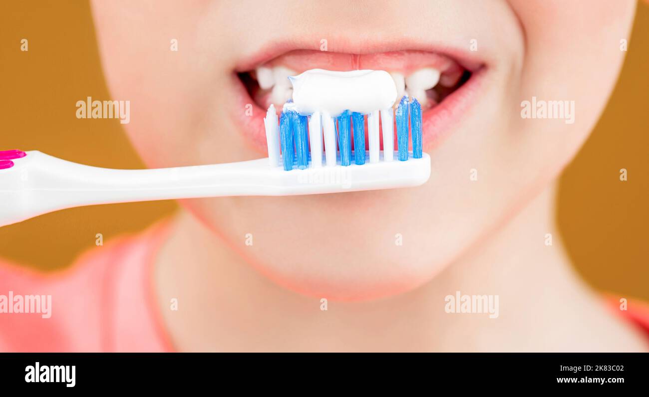 Dental hygiene. Happy little kid brushing her teeth. Health care, dental hygiene. Kid boy brushing teeth. Boy toothbrush white toothpaste. Joyful Stock Photo