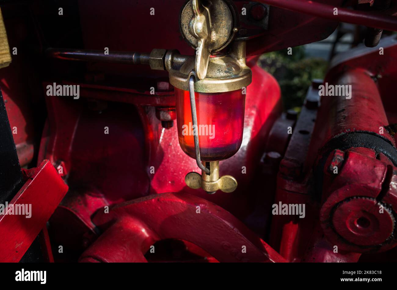 A glass fuel lift pump on a vintage tractor. Stock Photo