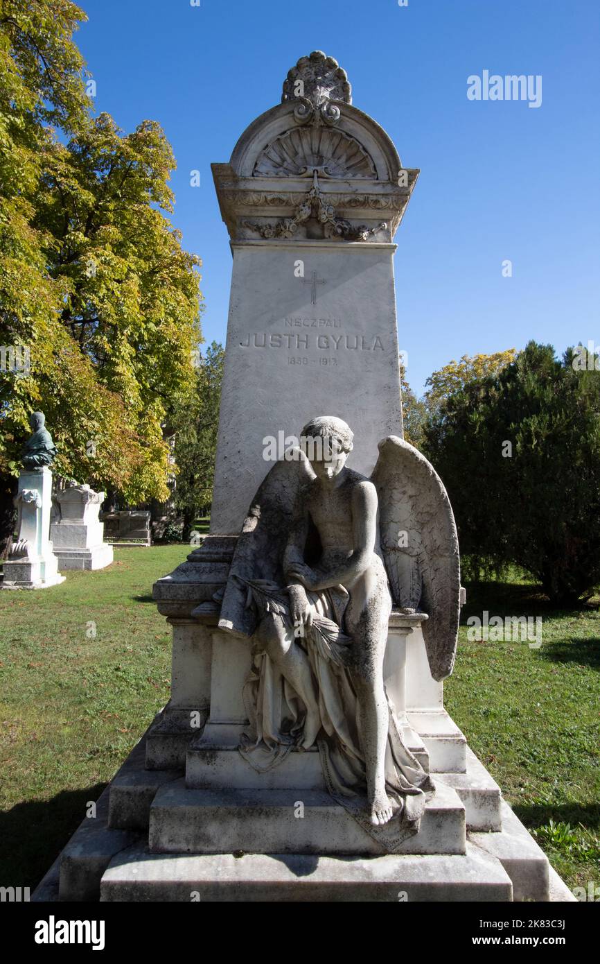A child angel sitting on a grave in Kerepesi Cemetery, Budapest Hungary Stock Photo