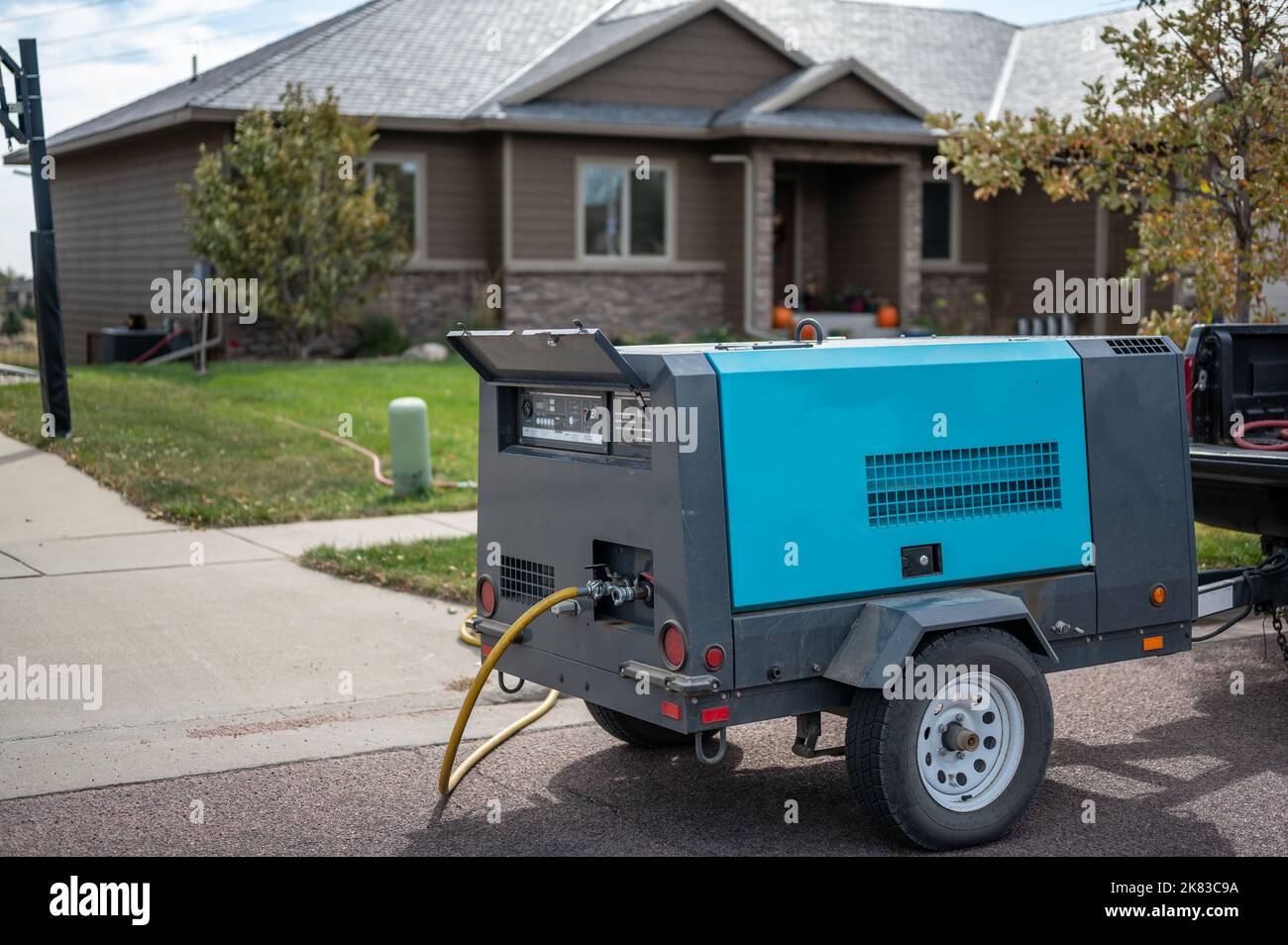 Winterizing a residential irrigation system by using a compressor and