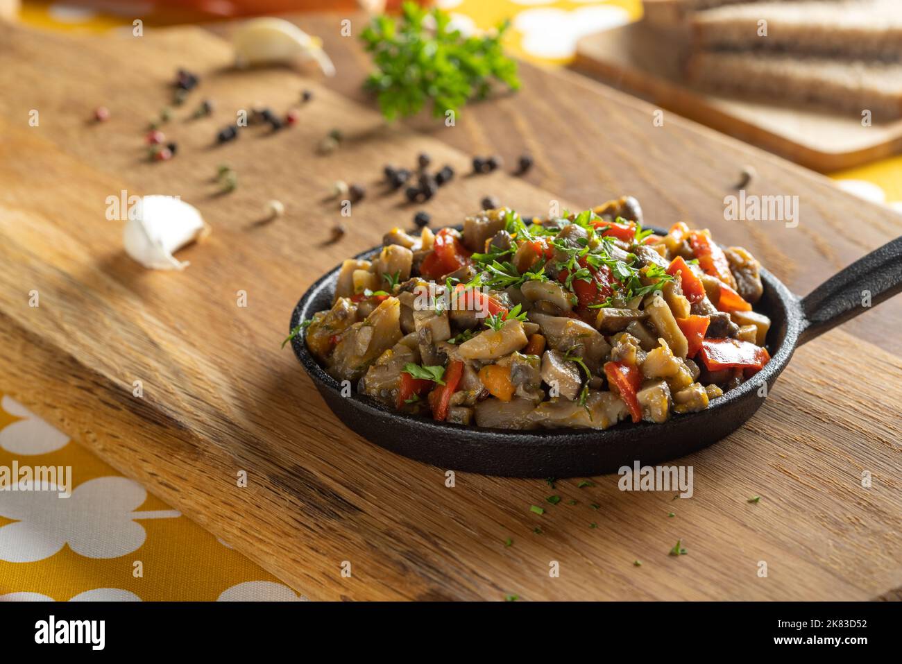 Mushroom stew with a lot of vegetables in a rustic background Stock Photo
