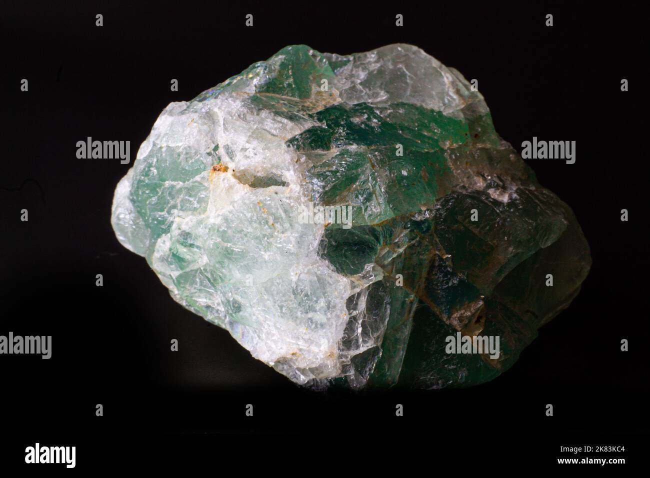 Macro rough green fluorite stone isolated on black surface Stock Photo