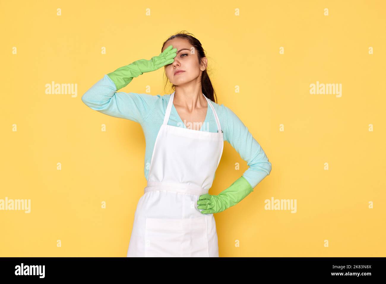 tired woman in gloves and cleaner apron Stock Photo - Alamy