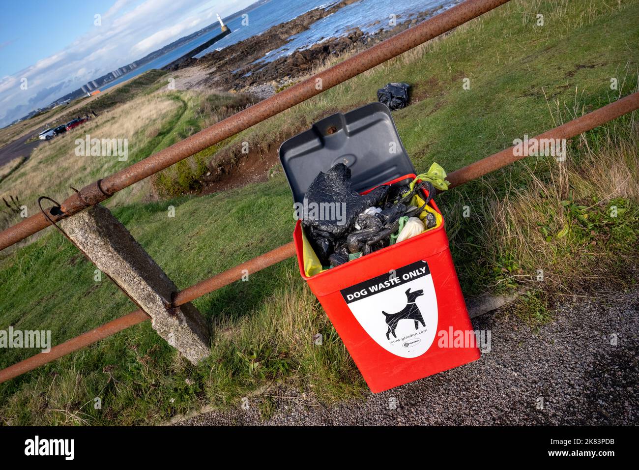 Full to overflowing dog waste bin near the Girdle Ness Lighthouse in Aberdeen. Stock Photo