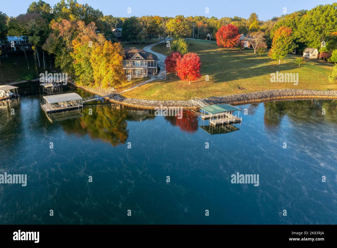 Aerial view of lakefront homes and floating boat docks with upper deck