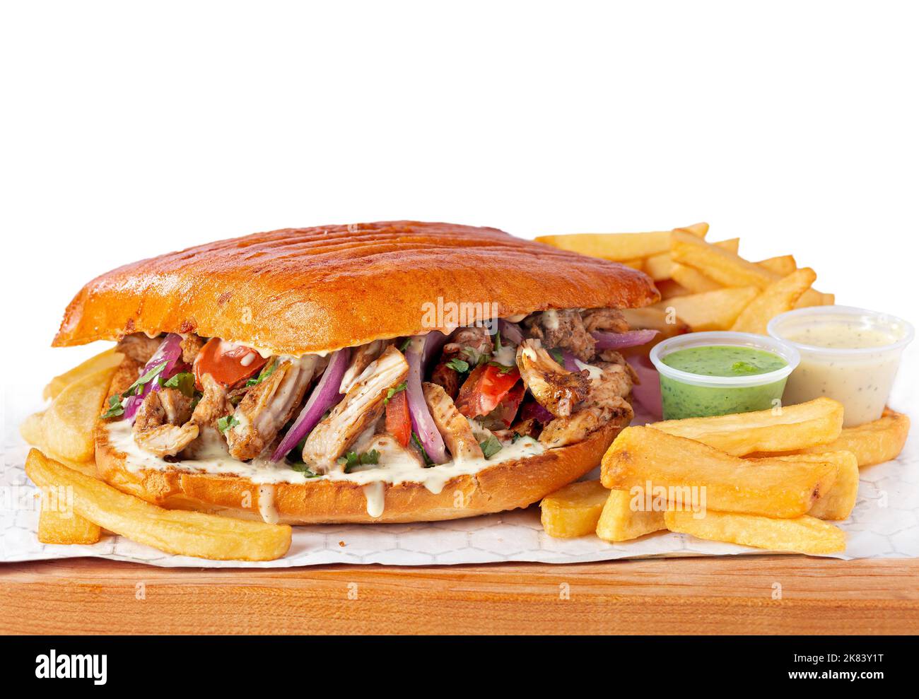 Large Peruvian Lomo saltado chicken sandwich with French fries on a white background Stock Photo