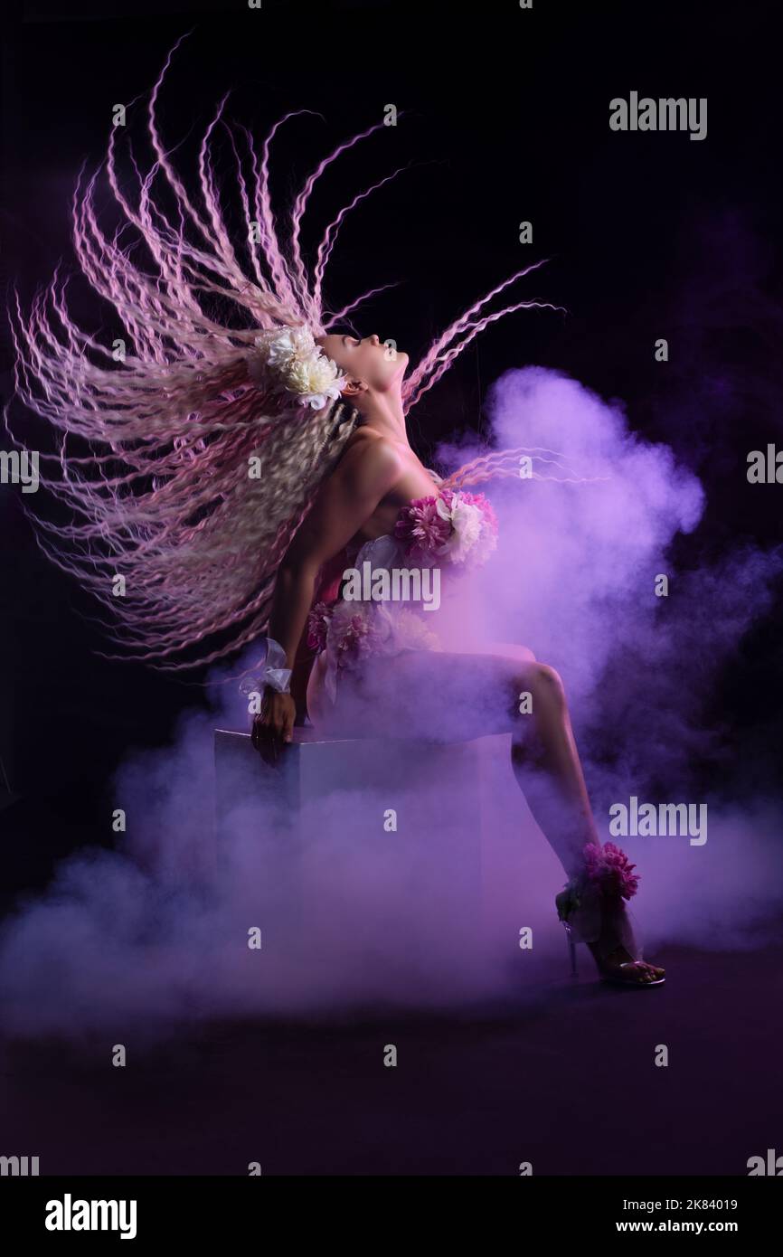 Sensual lady moving head while performing dance on stage Stock Photo