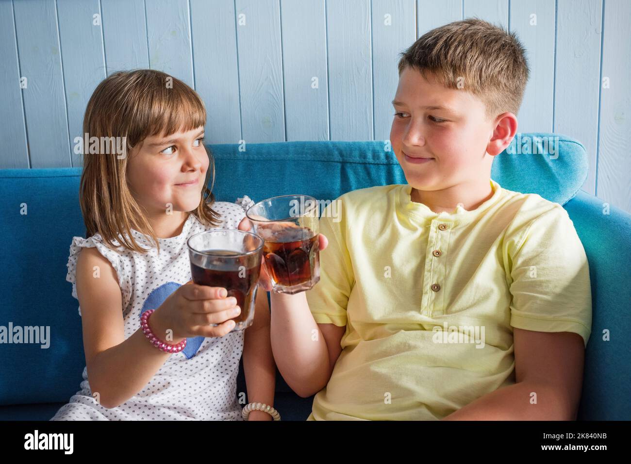 Children with cold, refreshing drinks in their hands. Soft drink Stock Photo